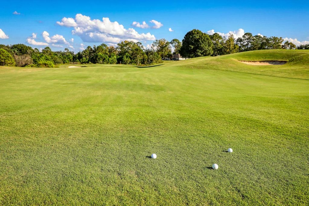 Panoramic view of a lush green golf course at Tri-pond Golf Course. Smooth