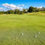 Panoramic view of a lush green golf course at Tri-pond Golf Course. Smooth