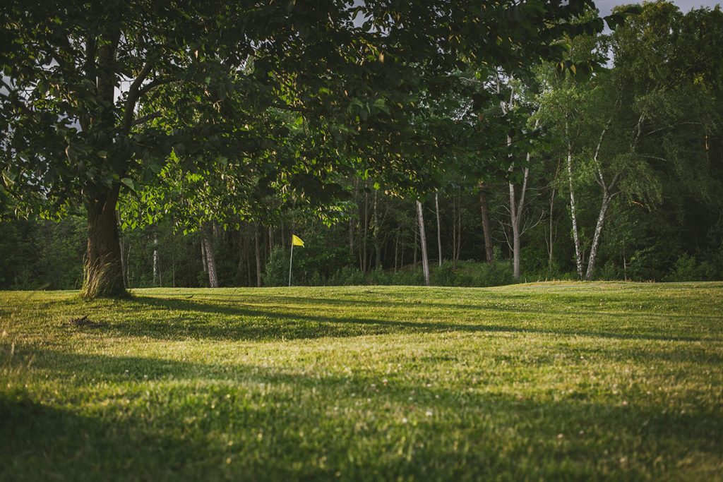 Panoramic view of a lush green golf course at University Club Clubhouse. Smooth