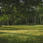 Panoramic view of a lush green golf course at University Club Clubhouse. Smooth