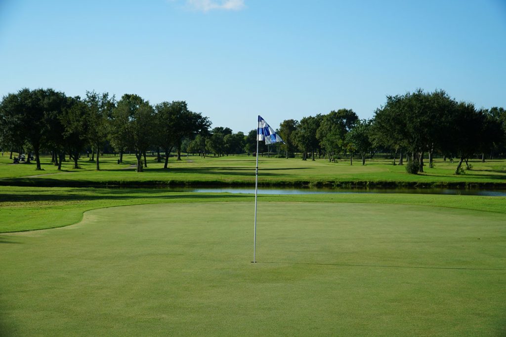 Panoramic view of a lush green golf course at Village Creek Golf Club. Smooth
