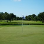 Panoramic view of a lush green golf course at Village Creek Golf Club. Smooth