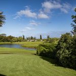 Panoramic view of a lush green golf course at Wellman Golf Course. Smooth