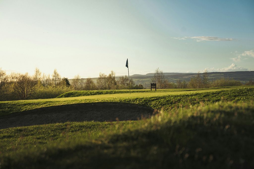 Panoramic view of a lush green golf course at Whitetail. Smooth