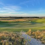 Panoramic view of a lush green golf course at Woodson Bend Resort. Smooth