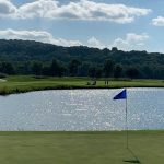 green grass with the flag in the hole.