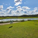 Panoramic view of a lush green golf course at Aberdeen Golf Club. Smooth