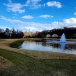 Panoramic view of a lush green golf course at Achasta Golf Club. Smooth