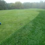 Panoramic view of a lush green golf course at Acushnet River Valley. Smooth
