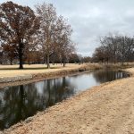 Panoramic view of a lush green golf course at Adams Municipal Golf Course. Smooth