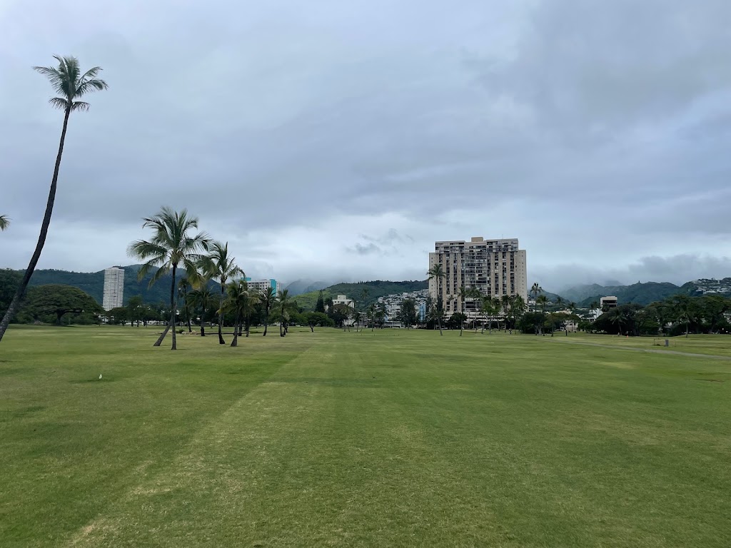 Panoramic view of a lush green golf course at Ala Wai Golf Course. Smooth
