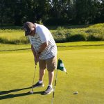 green grass with the flag in the hole.