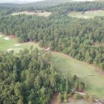 Panoramic view of a lush green golf course at Alotian Golf Club. Smooth
