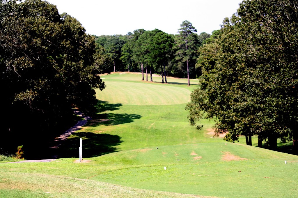 Panoramic view of a lush green golf course at Alpine Bay Golf Club. Smooth