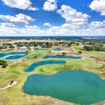 Panoramic view of a lush green golf course at Alsatian Golf Club. Smooth