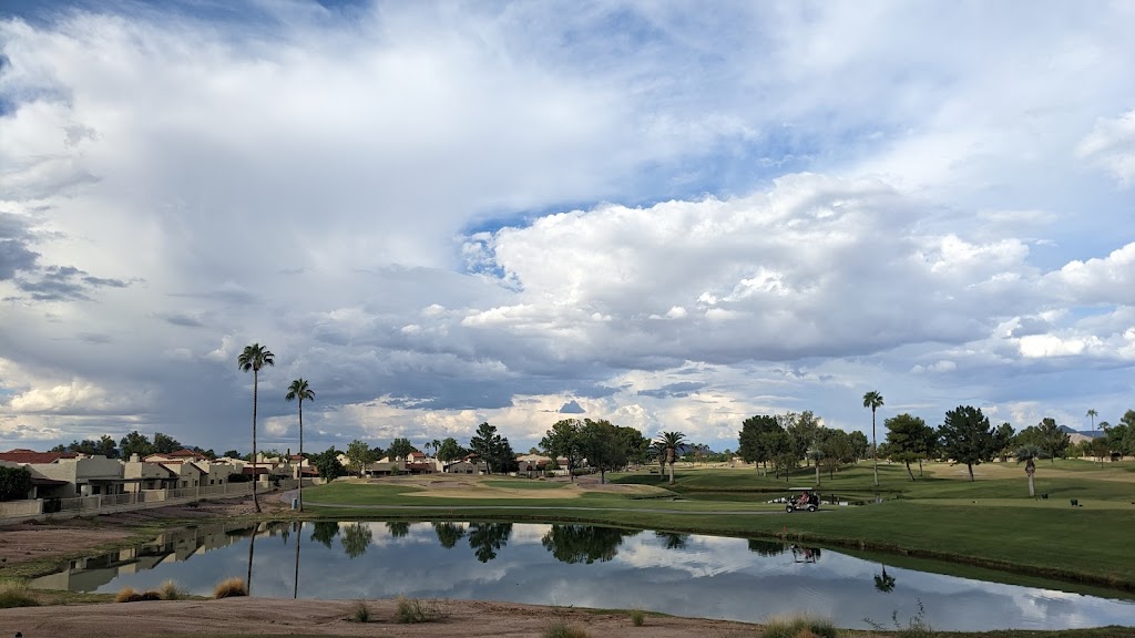 Panoramic view of a lush green golf course at Alta Mesa Golf Club. Smooth