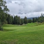 Panoramic view of a lush green golf course at Anchorage Golf Course. Smooth