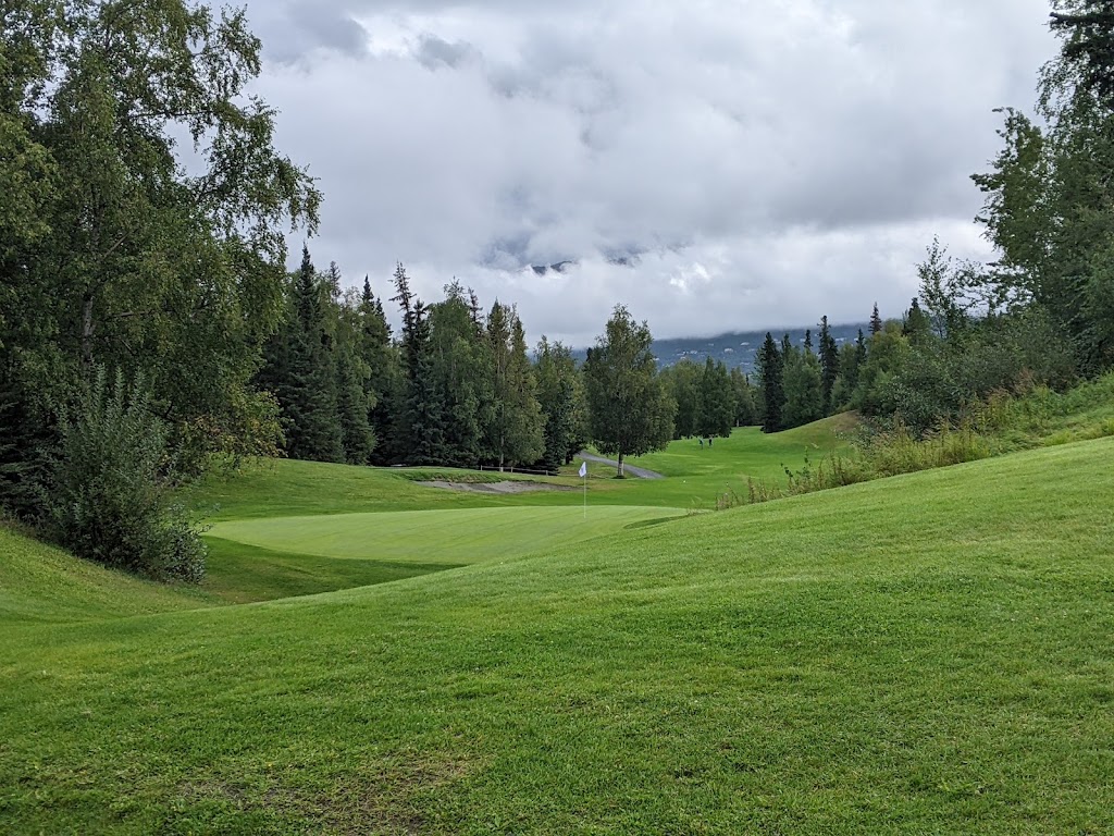 Panoramic view of a lush green golf course at Anchorage Golf Course. Smooth