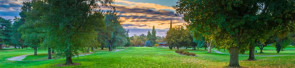 Panoramic view of a lush green golf course at Ancil Hoffman Golf Course. Smooth