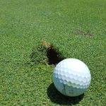 green grass with the flag in the hole.
