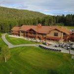 Panoramic view of a lush green golf course at Angel Fire Country Club. Smooth