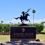 Panoramic view of a lush green golf course at Apache Wells Country Club. Smooth