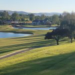 Panoramic view of a lush green golf course at Apple Tree Golf Course. Smooth