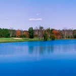 Panoramic view of a lush green golf course at Applewood Golf Course. Smooth