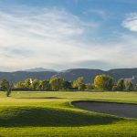 Panoramic view of a lush green golf course at Applewood Golf Course. Smooth