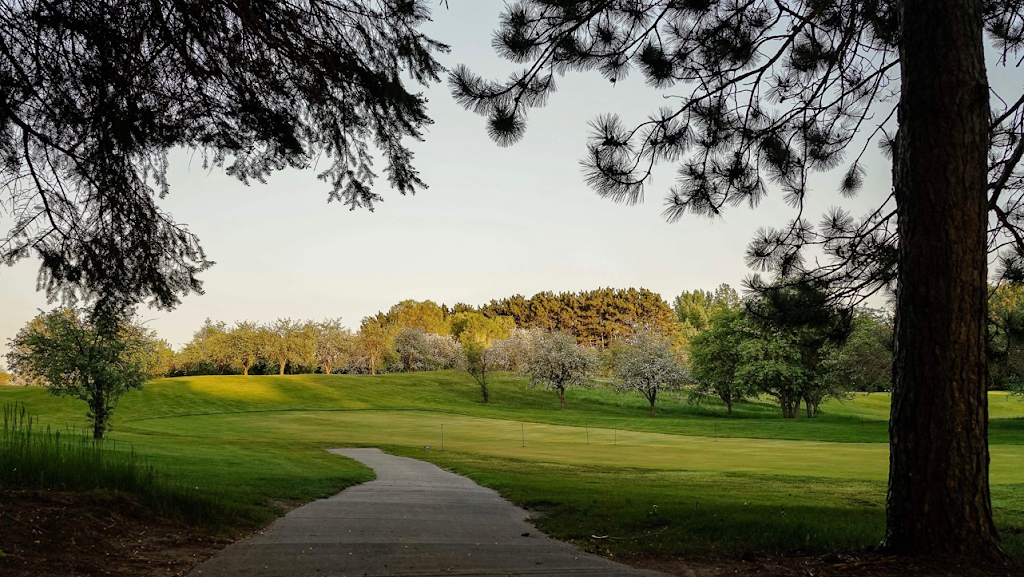 Panoramic view of a lush green golf course at Applewood Hills Golf Course. Smooth