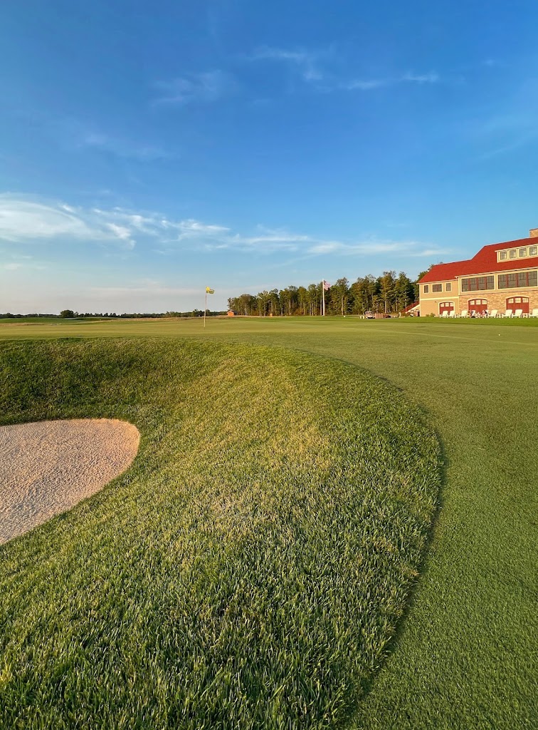 Panoramic view of a lush green golf course at Arcadia Bluffs South Course. Smooth