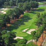 Panoramic view of a lush green golf course at Arcadian Shores Golf Club. Smooth