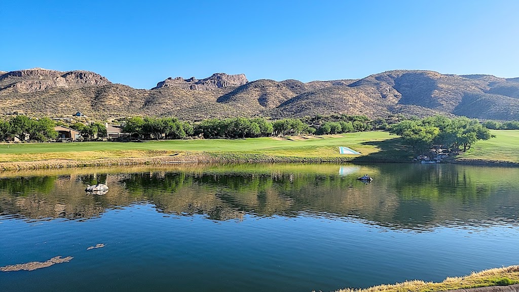 Panoramic view of a lush green golf course at Arizona National Golf Club. Smooth