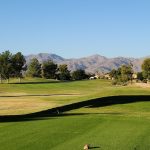 Panoramic view of a lush green golf course at Arizona Traditions Golf Club. Smooth