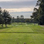 Panoramic view of a lush green golf course at Army Navy Country Club. Smooth