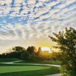 Panoramic view of a lush green golf course at Arrowhead Golf Club. Smooth