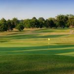 Panoramic view of a lush green golf course at Arthur B. Sim Golf Course. Smooth