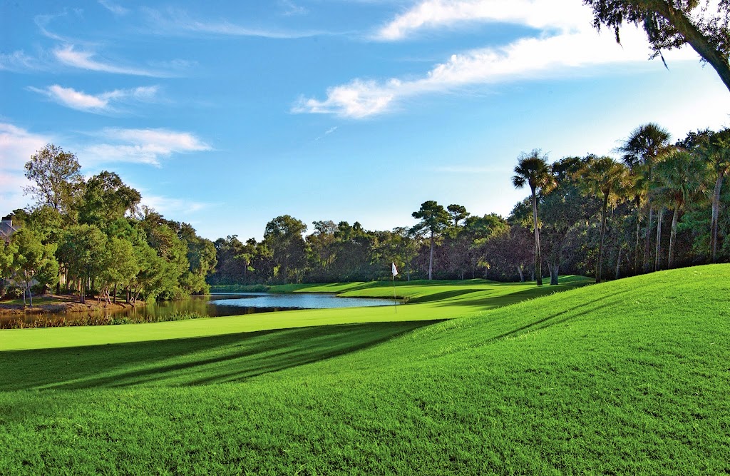 Panoramic view of a lush green golf course at Arthur Hills Golf Course. Smooth