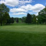 Panoramic view of a lush green golf course at Ashland Golf Club. Smooth