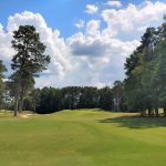Panoramic view of a lush green golf course at Ashton Hills Golf Club. Smooth