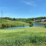 Panoramic view of a lush green golf course at Aston Oaks Golf Club. Smooth
