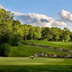 Panoramic view of a lush green golf course at Atkinson Resort & Country Club. Smooth