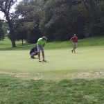 green grass with the flag in the hole.