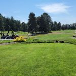 Panoramic view of a lush green golf course at Auburn Golf Course. Smooth