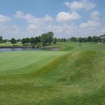 green grass with the flag in the hole.