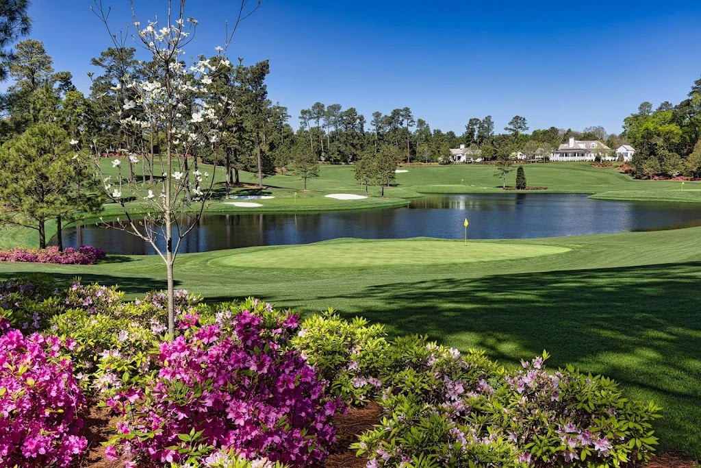 Panoramic view of a lush green golf course at Augusta National Golf Club. Smooth