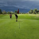 green grass with the flag in the hole.