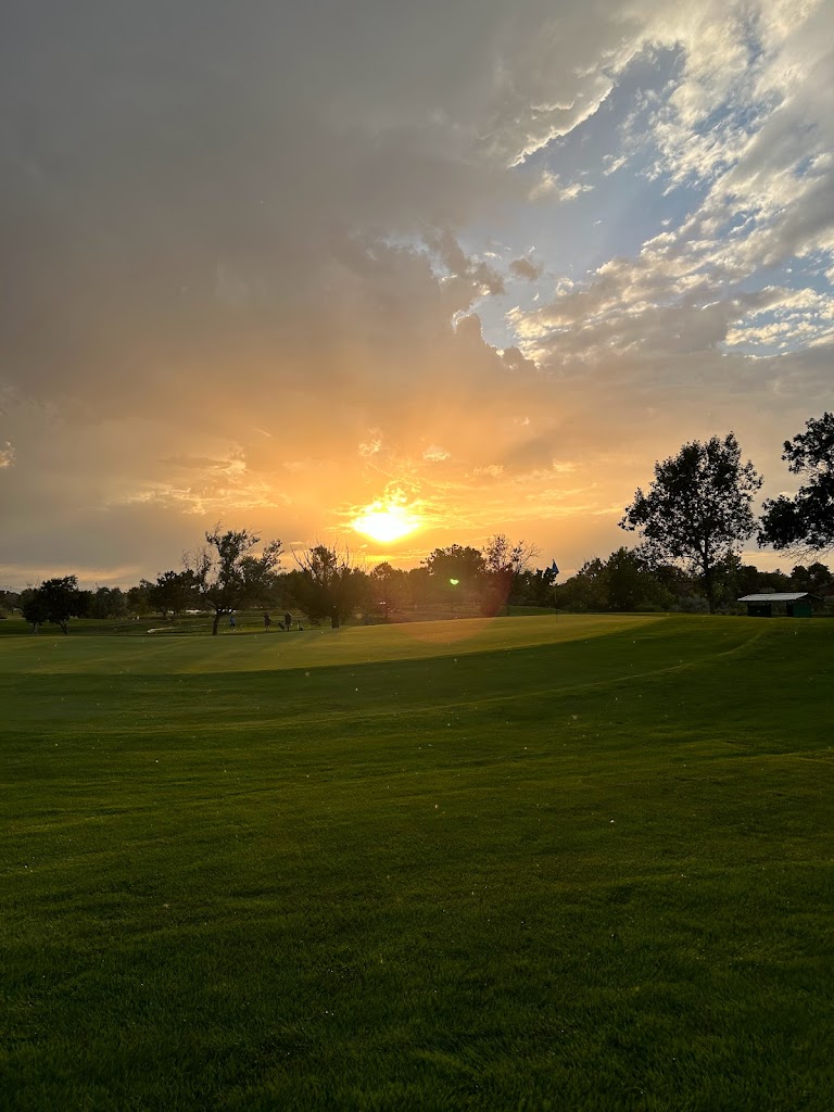 Panoramic view of a lush green golf course at Aurora Hills Golf Course. Smooth