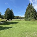 Panoramic view of a lush green golf course at Avalon Golf Links. Smooth