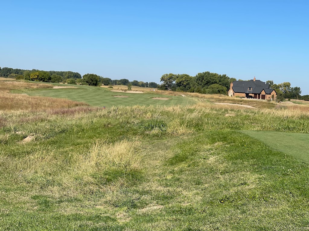 Panoramic view of a lush green golf course at Awarii Dunes Golf Course. Smooth